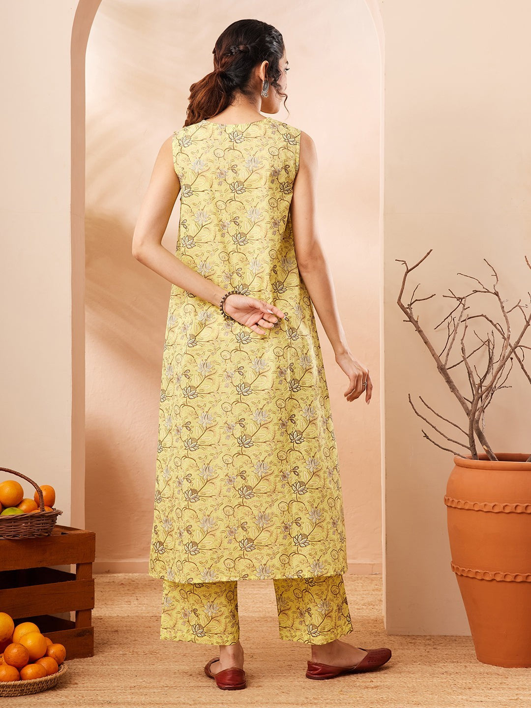 Naanu yellow lotus print sleeveless A-line kurta with V-neck and matching wide-leg palazzo pants.